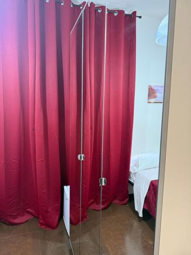 a group of red curtains in a room with a bed at Sc Residence Parma in Parma