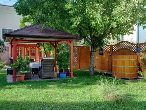 a gazebo with a table in a yard at Hametner mit Innviertlerhaus mit Thermenzugang in Bad Hall