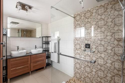 a bathroom with two sinks and a shower at 5 bedroom house near Disneyland Paris in Serris