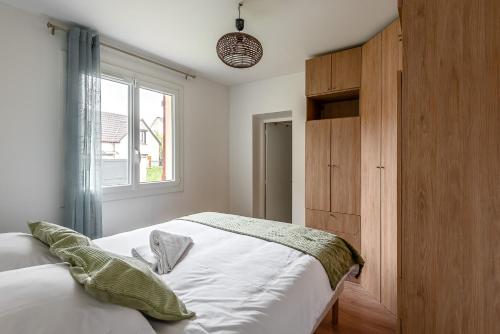 a bedroom with a white bed and a window at 5 bedroom house near Disneyland Paris in Serris