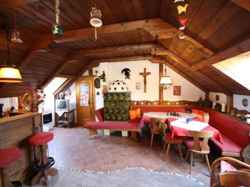 a living room with a table and chairs and a cross on the wall at Apartment in Lungau near Ski Bus and Forest in Sankt Michael im Lungau