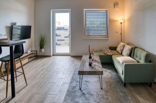 a living room with a couch and a table at DUO Residences in Dunajská Streda