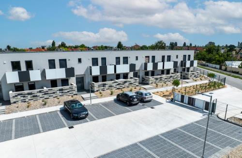 a building with solar panels in a parking lot at DUO Residences in Dunajská Streda
