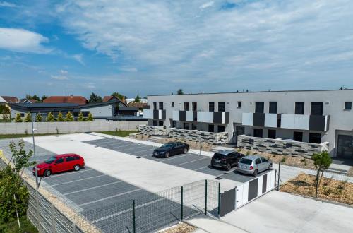 a parking lot with cars parked in front of buildings at DUO Residences in Dunajská Streda