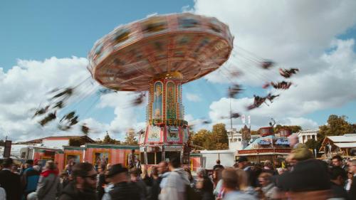 a crowd of people standing around a carnival ride at Holiday Inn Express Munich - City East by IHG in Munich