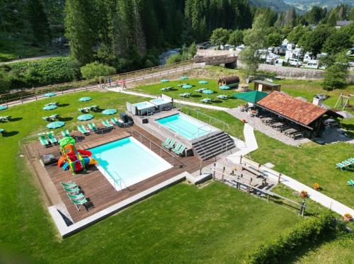 an aerial view of a resort with a swimming pool at Hotel Rubino Deluxe in Campitello di Fassa