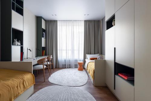 a hotel room with two beds and a desk at A27 Apartments in Almaty