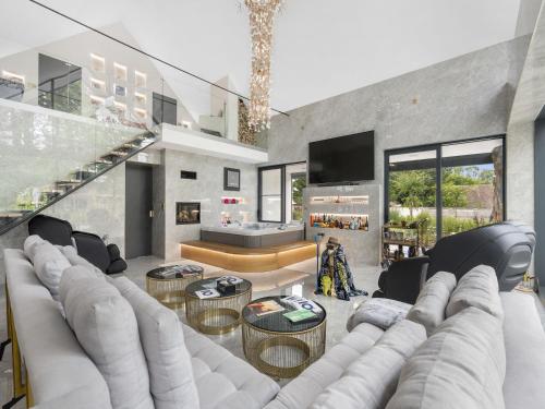 a living room with a large couch and a tv at Holiday Home Ayurvedic Palace by Interhome 
