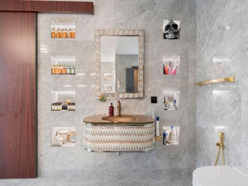 a bathroom with a sink and a mirror at Holiday Home Ayurvedic Palace by Interhome 