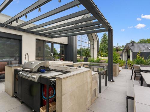 an outdoor kitchen with a grill and a patio at Holiday Home Ayurvedic Palace by Interhome 