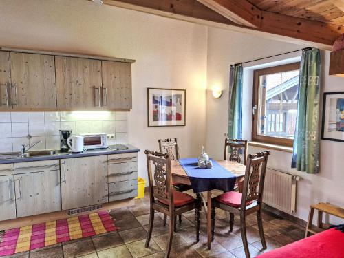 a kitchen with a table and chairs and a sink at Apartment Am Weitfeld-3 by Interhome in Längenfeld