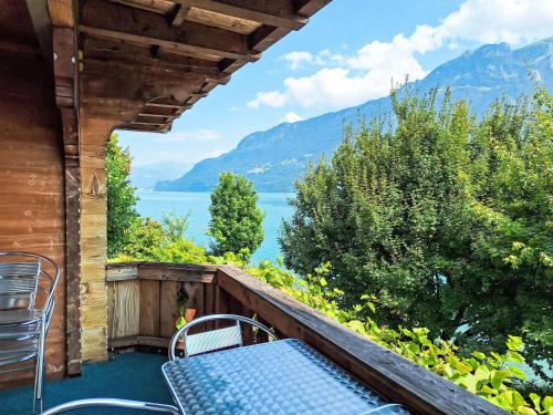 a balcony with a view of a lake and mountains at Chalet Haus am See by Interhome in Niederried