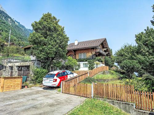 a car parked in front of a house at Chalet Haus am See by Interhome in Niederried