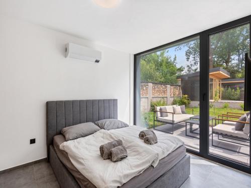 a bedroom with a bed with two stuffed animals on it at Holiday Home Romance & Relax Villa by Interhome 
