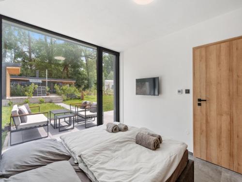 a bedroom with a large bed and a large window at Holiday Home Romance & Relax Villa by Interhome 