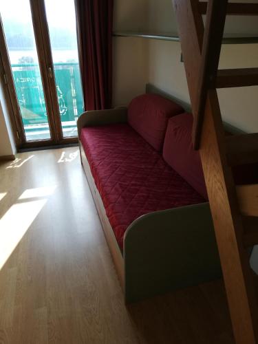 a couch in a room with a large window at Residenza Lorica in Lorica