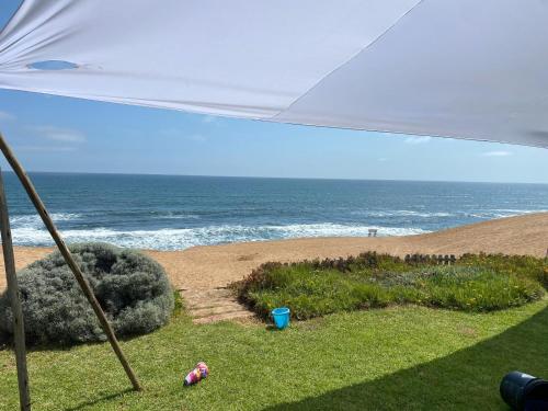 a view of the ocean from a beach under an umbrella at 3 bedroom house with magnificent ocean views in Hentiesbaai