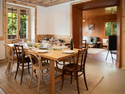 a dining room with a wooden table and chairs at Chalet Quinette by Interhome in Ovronnaz