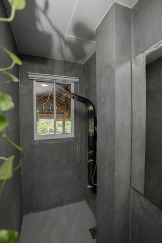 a shower in a bathroom with a window at Goalie Beachfront Resort in Hikkaduwa