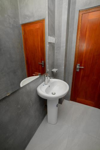 a bathroom with a sink and a toilet at Goalie Beachfront Resort in Hikkaduwa