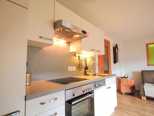 a kitchen with a sink and a stove top oven at Apartment Alpenfarm Poschhof by Interhome in Kaunerberg