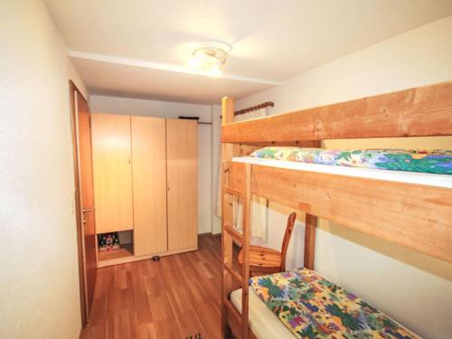 a room with two bunk beds and a closet at Apartment Alpenfarm Poschhof by Interhome in Kaunerberg