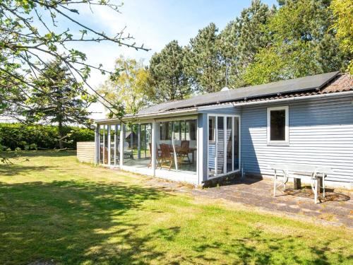 a house with a conservatory and a patio at 5 person holiday home in Odder-By Traum in Odder