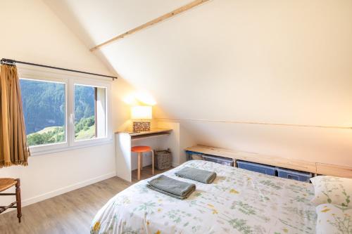 a bedroom with a bed and a window at Le Chazelet - Splendide Vue Montagne in La Grave