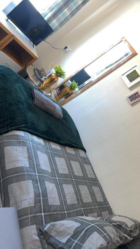 a bedroom with a bed in a room at QueensBerry Hotel in Annan