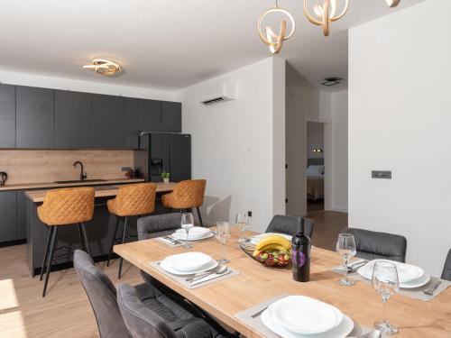 a kitchen and dining room with a wooden table and chairs at Holiday Home Sime by Interhome in Maslenica