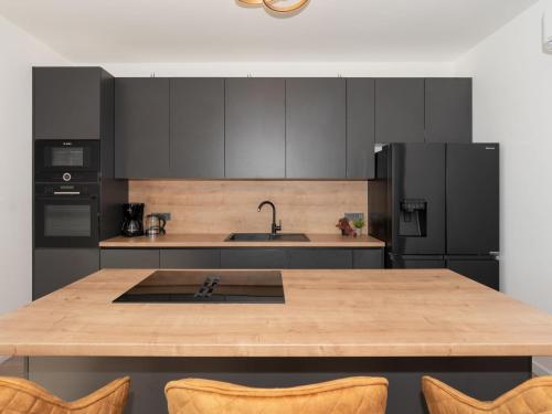 a kitchen with a wooden table and black appliances at Holiday Home Sime by Interhome in Maslenica
