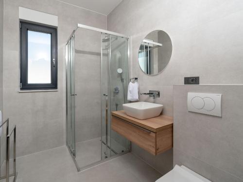 a bathroom with a sink and a shower at Holiday Home Sime by Interhome in Maslenica