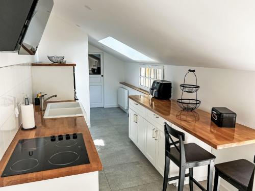 a kitchen with a sink and a stove top oven at Holiday Home Le petit Papeu by Interhome in Frehel