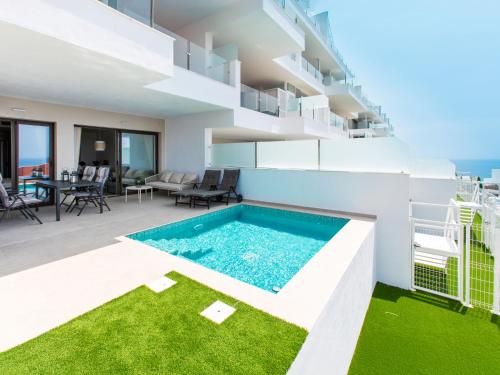 an apartment with a swimming pool on a building at Apartment Heaven Free Spa & Padel by Interhome in Torrox Costa