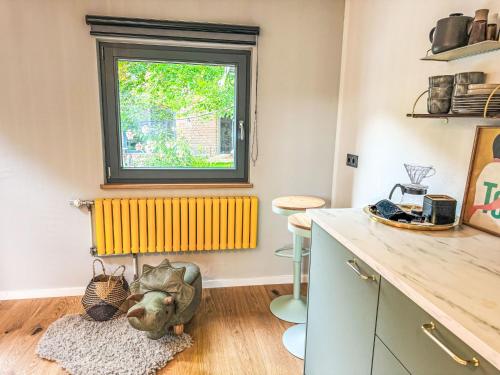 a kitchen with a window and a wooden floor at Apartment Hinterhov Koje by Interhome in Beeskow