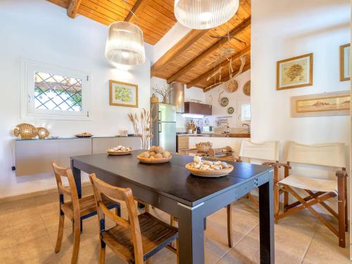 a kitchen and dining room with a table and chairs at Holiday Home Chidda Di by Interhome in Trudda