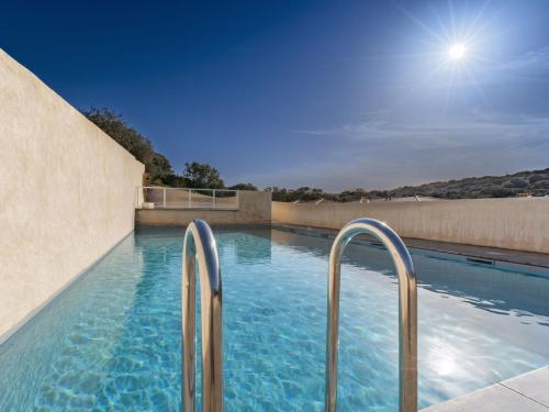 una piscina con barandillas metálicas en un edificio en Apartment Foce Dell Edera-4 by Interhome, en Bonifacio