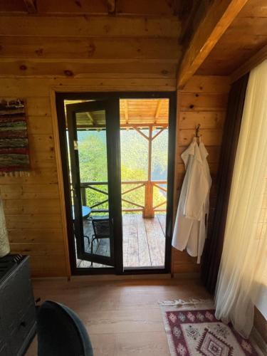 a room with a door leading to a deck at Chateau Maxuntseti in K'veda Bzubzu