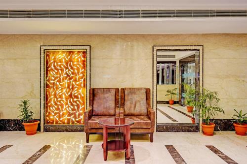 a room with a chair and a table and a mirror at Super Townhouse OAK Hotel City Mark Gurgaon in Gurgaon