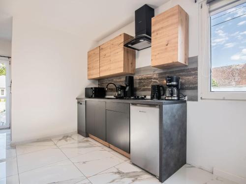 a kitchen with stainless steel appliances and a window at Holiday Home Gęsia Kępa by Interhome 