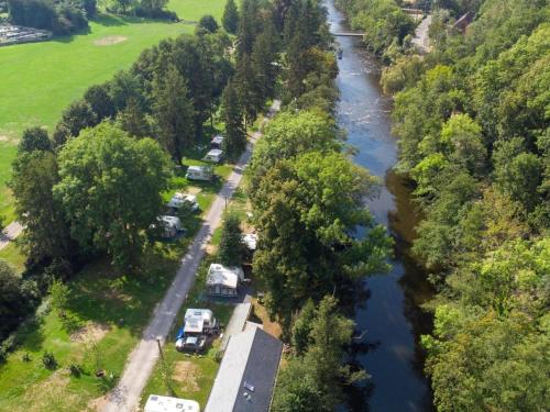 an aerial view of a river with a group of vehicles parked at Cozy Apartment in a 16th Century Castle in Aywaille