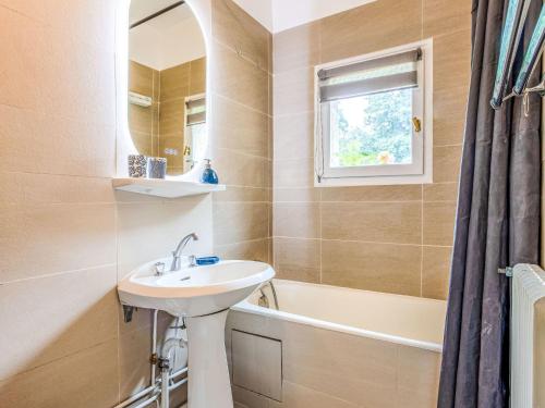 a bathroom with a sink and a mirror at Apartment La Pinchonnière-8 by Interhome in Tourgeville