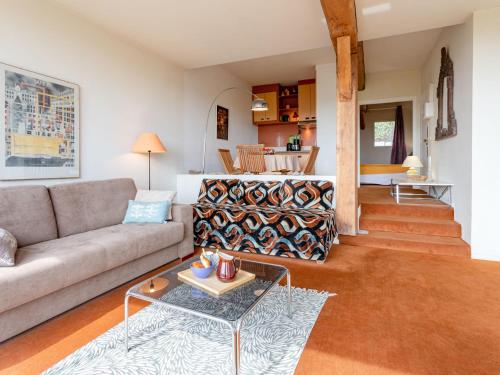 a living room with a couch and a table at Apartment La Pinchonnière-8 by Interhome in Tourgeville