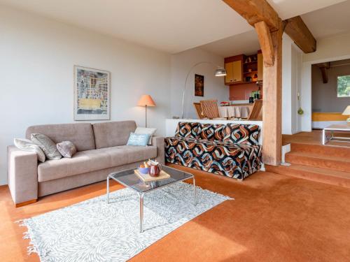 a living room with a couch and a table at Apartment La Pinchonnière-8 by Interhome in Tourgeville