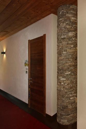 a room with a door and a stone wall at Chalet ALLEMAND in Sauze dʼOulx