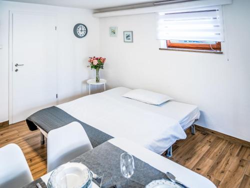 a hospital room with two beds and a table at Apartment Adelsberg Inn-2 by Interhome in Postojna