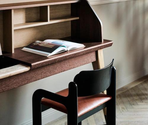 a desk with a chair and a book on it at Telegraphenamt in Berlin