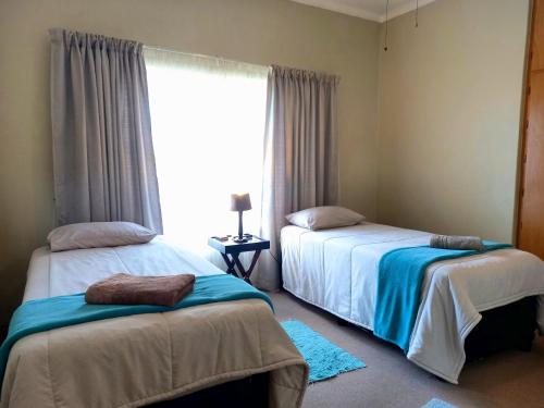 Ένα ή περισσότερα κρεβάτια σε δωμάτιο στο Cairos Guest House