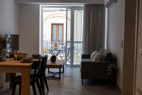 a living room with a couch and a table at Downtown Central Apartments in Msida