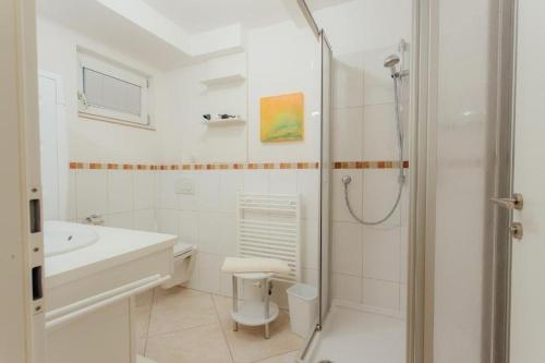 a bathroom with a shower and a toilet and a sink at Chalet SOLYMONT by MoniCare in Seefeld in Tirol
